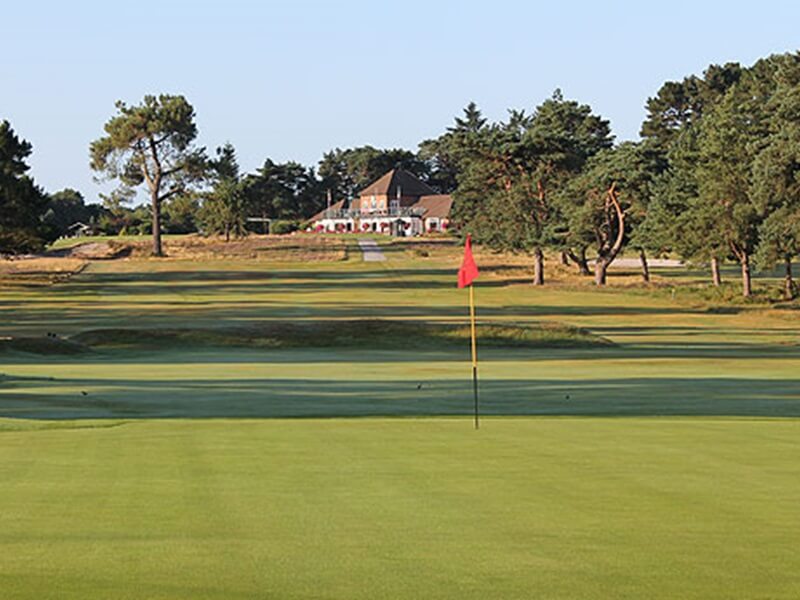 Ferndown golf club old coursered flag, club house, trees, golf trip, holidays in england